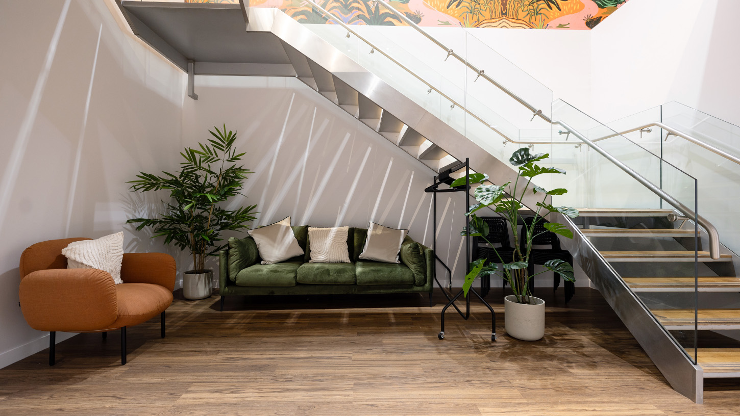 Light filled stairway with soft seating and plants