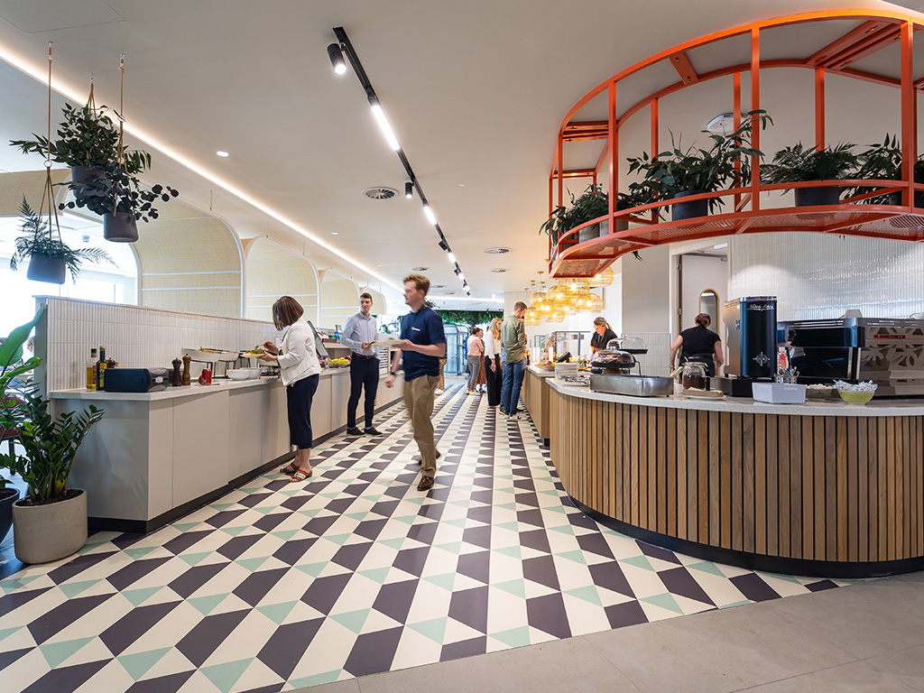 Osborne Clarke canteen with chequered tile floor and red metal work