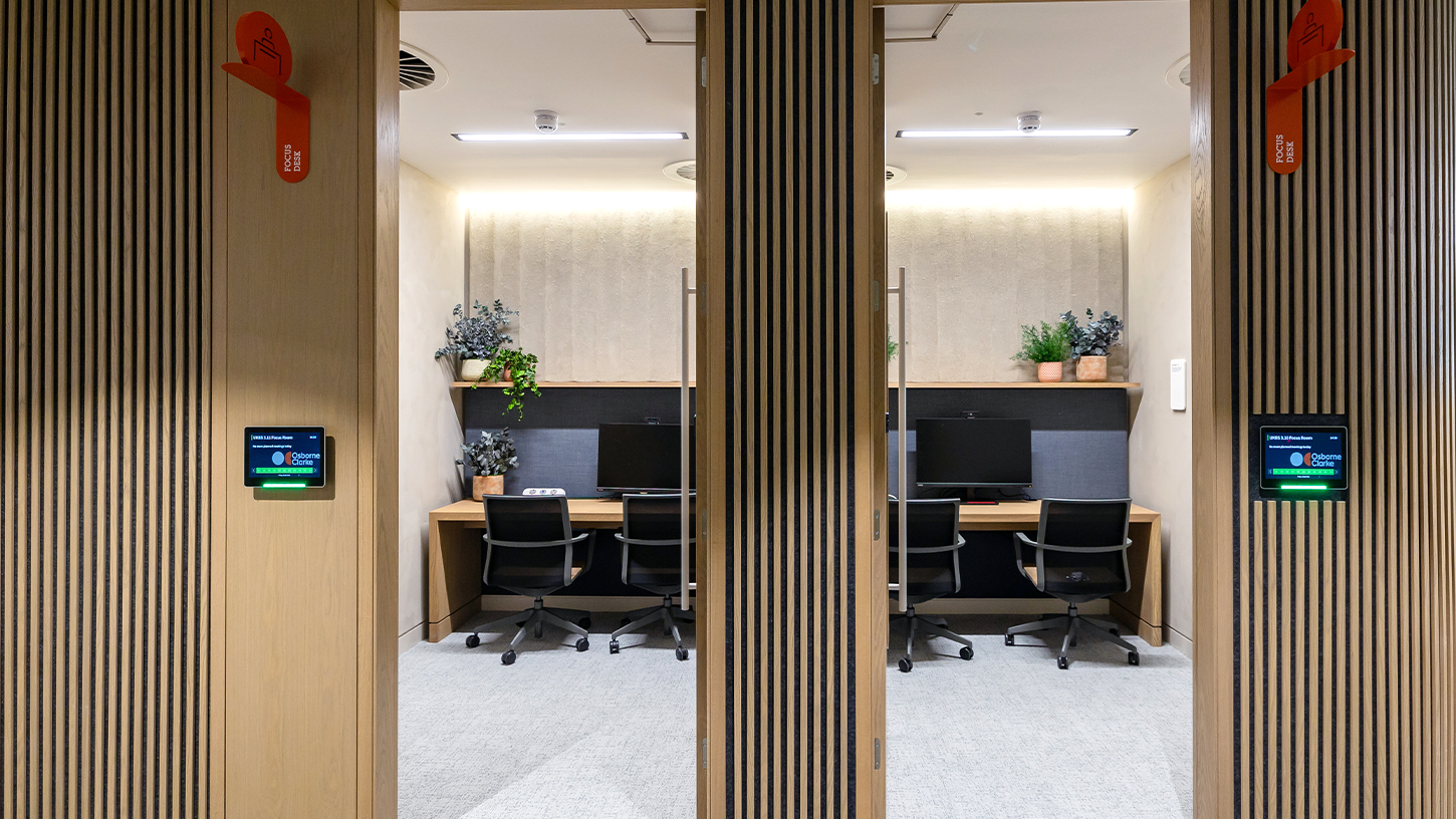 View into two office focus rooms with wood slat walls and acoustic panelling