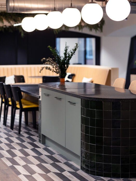 Office teapoint with dark green tiled bar and statement patterned floor tiles