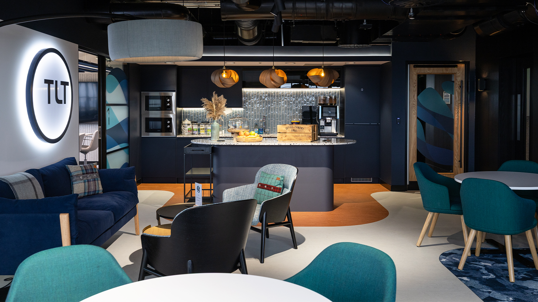 Office breakout space with kitchen and soft seating