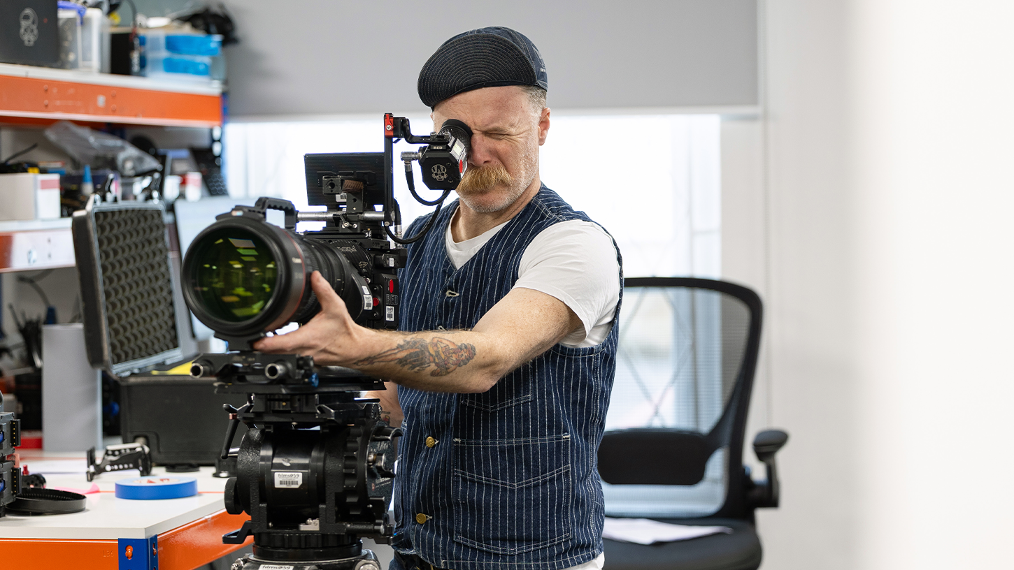 Man uses professional film camera in film kit room