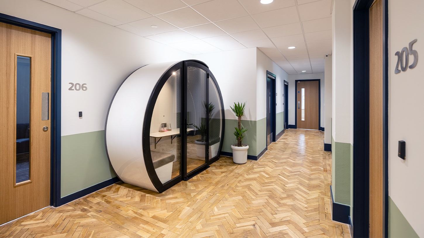 Office corridor with original oak parquet flooring and focus booth