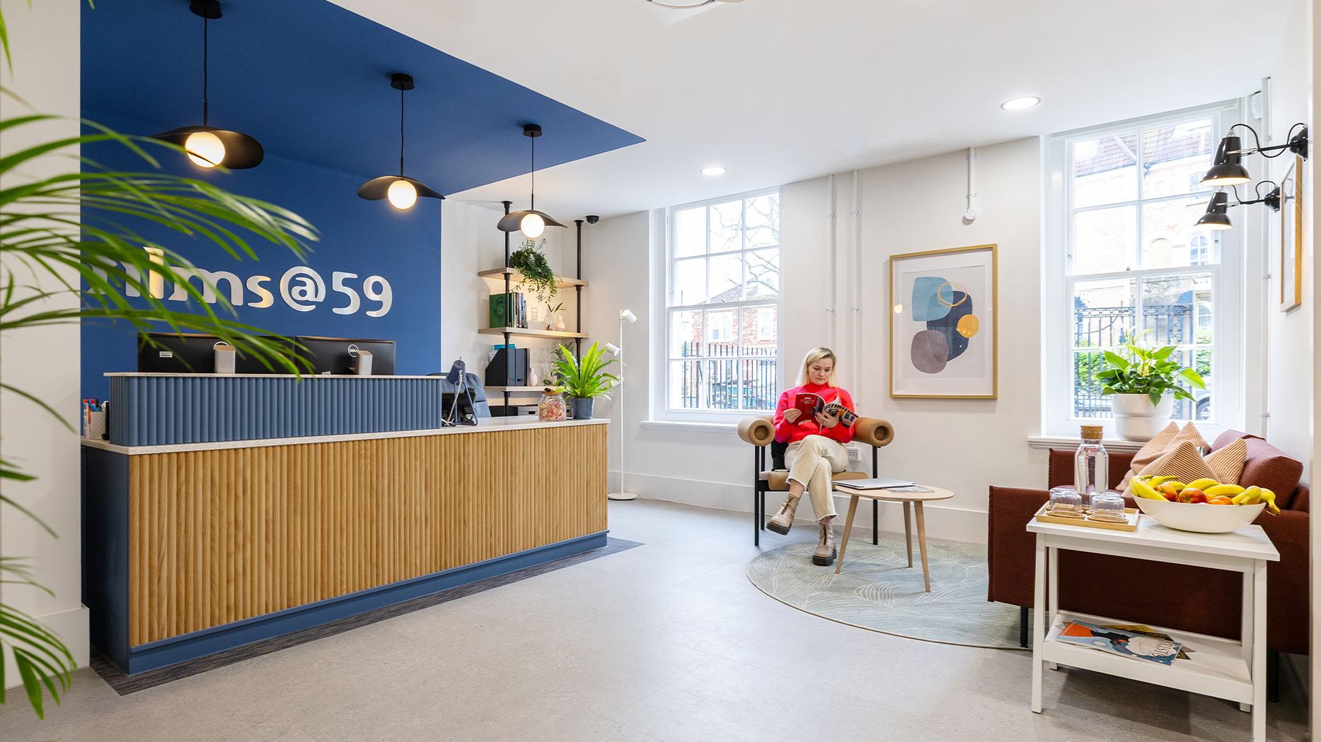 Office reception space with feature navy wall and timber reception desk